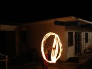 A hippie twirling a fire stick