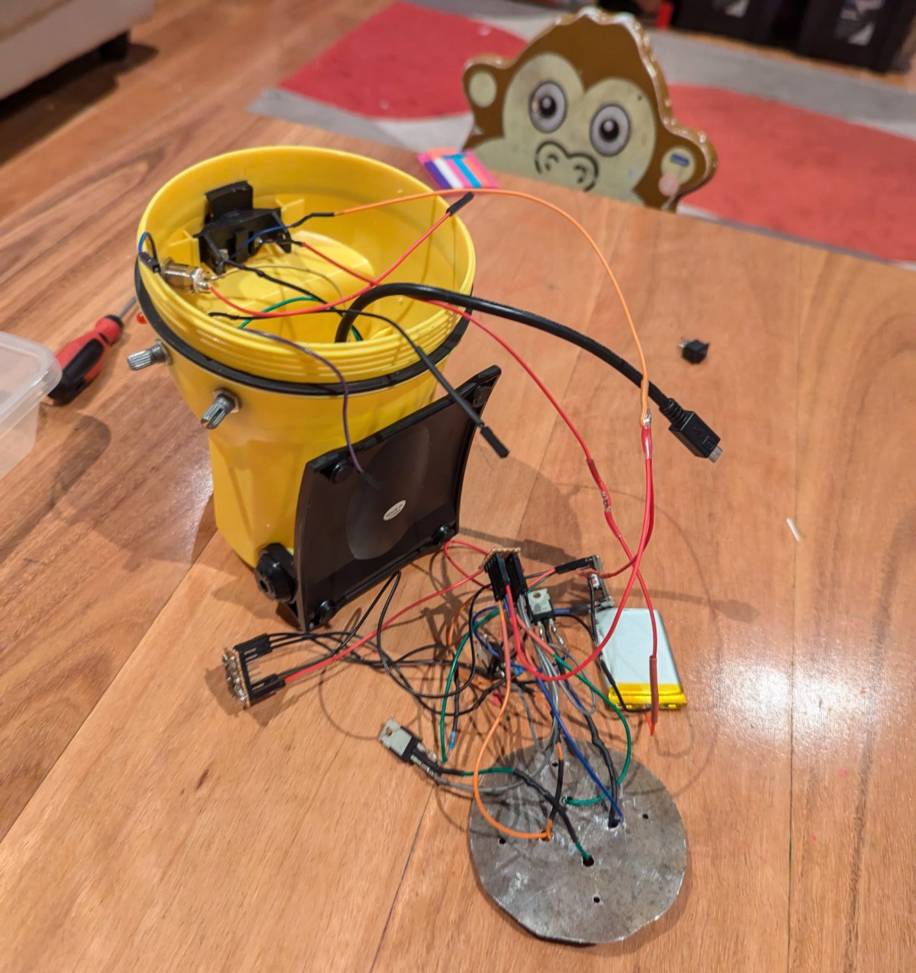 Opened yellow torch body on a table with the electronics about to go inside