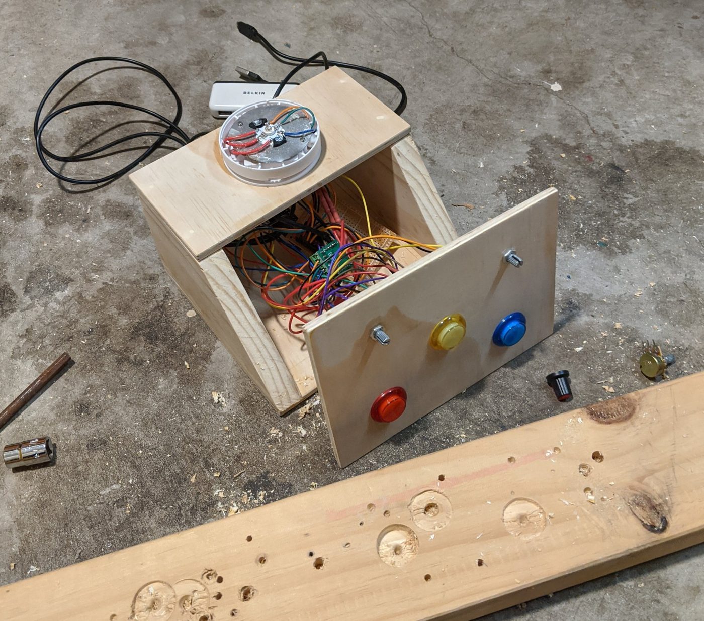Night light box mid build with the RGB LED mounted on the lid, wires inside and the yellow, blue and red buttons fitted to the front panel